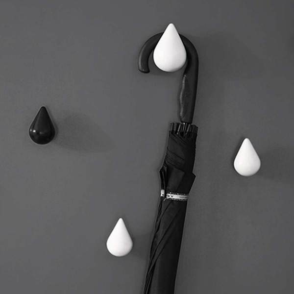 Kreativt set med 4 droppformade klädkrokar för väggmontering, modern design