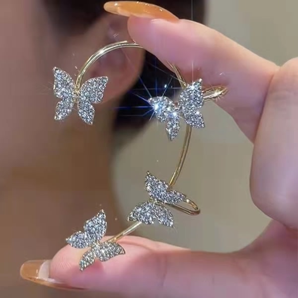 Ett par diamantbeströdda fjärilsörhängen utan hål i öronen. Guld