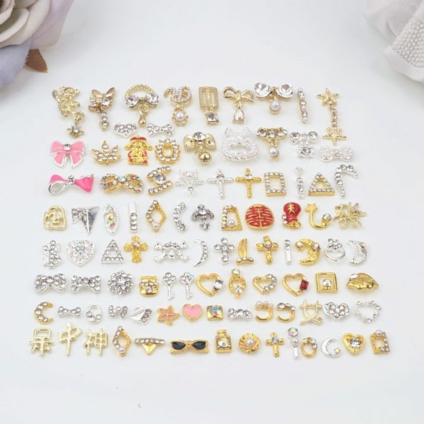 Neglecharms til akrylnegle med kunstige neglesten og rhinsten. Neglemetalsmykker blandet med diamantindlæg