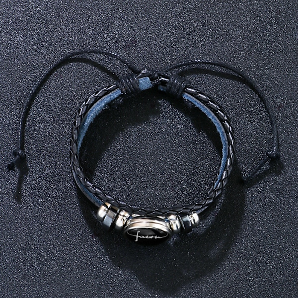 Svart läderarmband med spänne i glas med trosmotiv