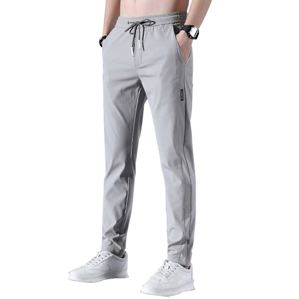 Snabbtorkande stretchiga sportbyxor för män, andningsbara joggingbyxor med dragsko i midjan och fickor - Grå