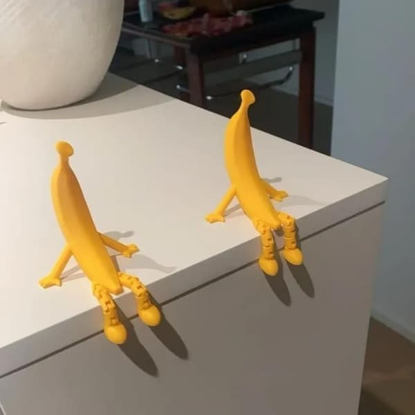 Funny 3D Printed Banana Sculpture with Adjustable Legs and a Unique Shape Perfect as a Decorative Item.