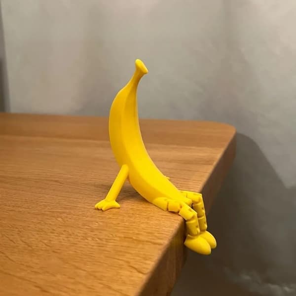 Funny 3D Printed Banana Sculpture with Adjustable Legs and a Unique Shape Perfect as a Decorative Item.