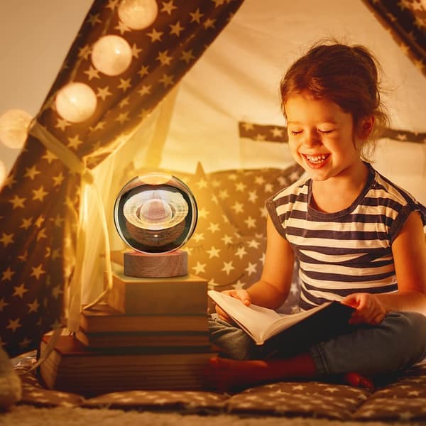 This 3D Saturn Crystal Ball Night Light features a colorful LED base with color-changing lights and comes with a remote control.