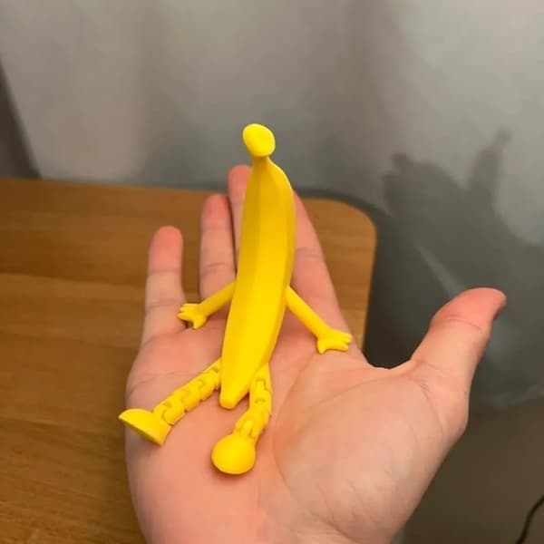 Funny 3D Printed Banana Sculpture with Adjustable Legs and a Unique Shape Perfect as a Decorative Item.