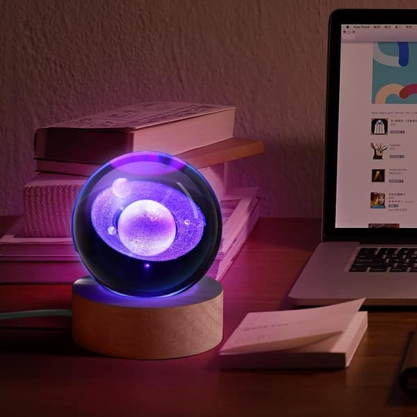 This 3D Saturn Crystal Ball Night Light features a colorful LED base with color-changing lights and comes with a remote control.