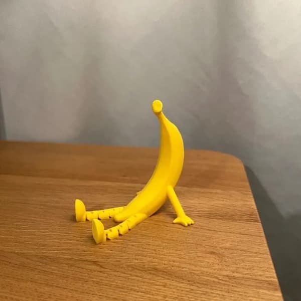 Funny 3D Printed Banana Sculpture with Adjustable Legs and a Unique Shape Perfect as a Decorative Item.