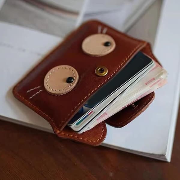 Retro cat-themed compact card holder with multiple card slots for cash and essentials.