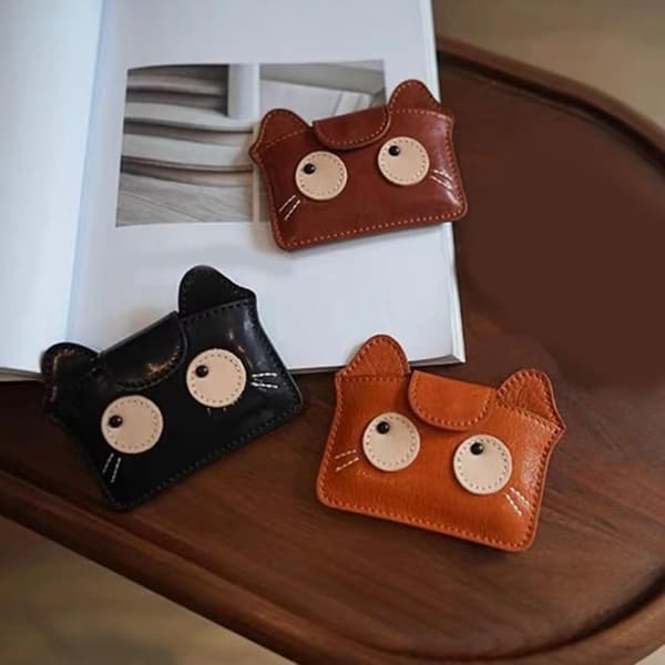 Retro cat-themed compact card holder with multiple card slots for cash and essentials.
