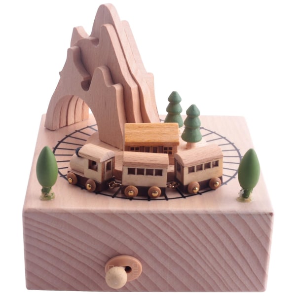 Puinen musiikkilaatikko, jossa on vuoristotunneli ja pieniä liikkuvia magneettijunasoittoja