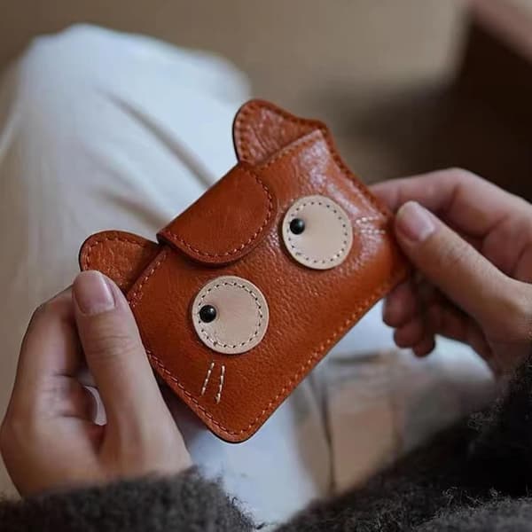 Retro cat-themed compact card holder with multiple card slots for cash and essentials.