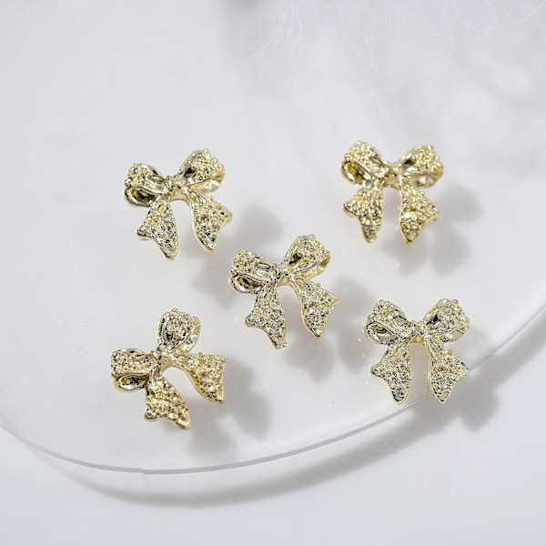 10 st guld bågnitar 3D legering nagelkonst charm söta bågknutar glänsande nageldekorationer plätering charm för naglar guld N