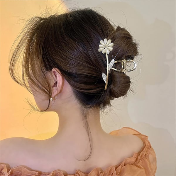 Elegantti kultainen daisy-klipsi, jossa strassit takana