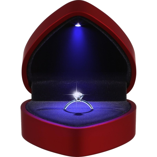 Hjärtformad ringask med ljus smyckeskrin med ljust bröllopsförlovningsförslag rött)