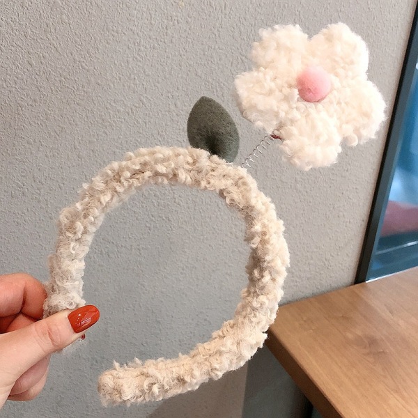 Skickar dig ett sött blompannband med en liten röd blomma White