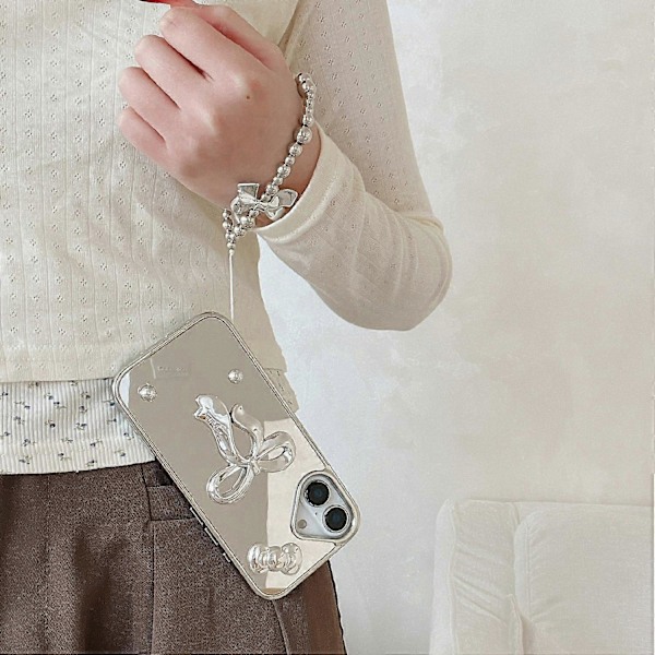 Skal till iPhone 16 3D Rosett Spegelyta Design Telefon Baksida med Rem