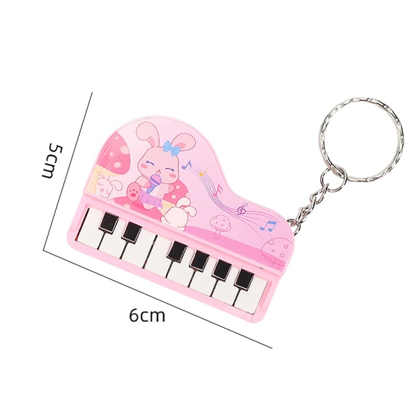 Musik elektroniskt piano Nyckelringar Minimusikaliskt instrumenterar piano Pink