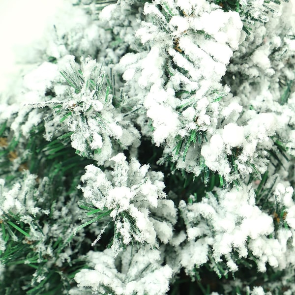 Snöflockad konstgjord julgran med träfot, liten kap