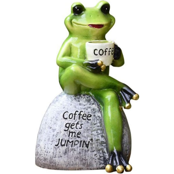 Kronfroskprinsstatue som ligger i gyngestol og drikker kaffe