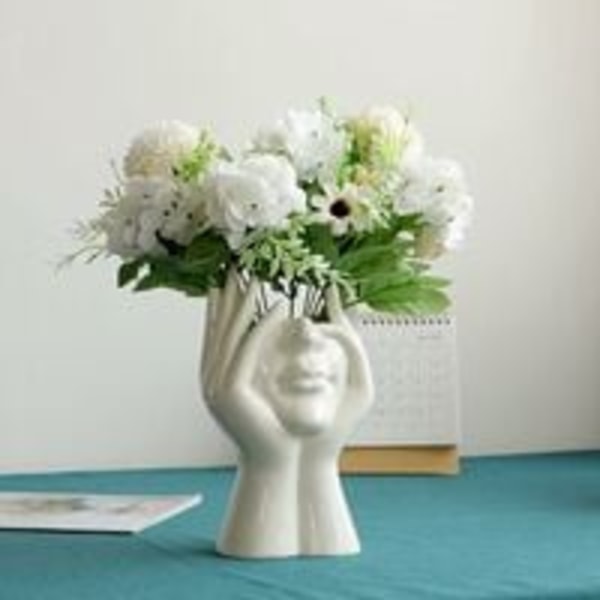 Hvit keramisk blomstervase Moderne design Blomstervase med menneskeansikt