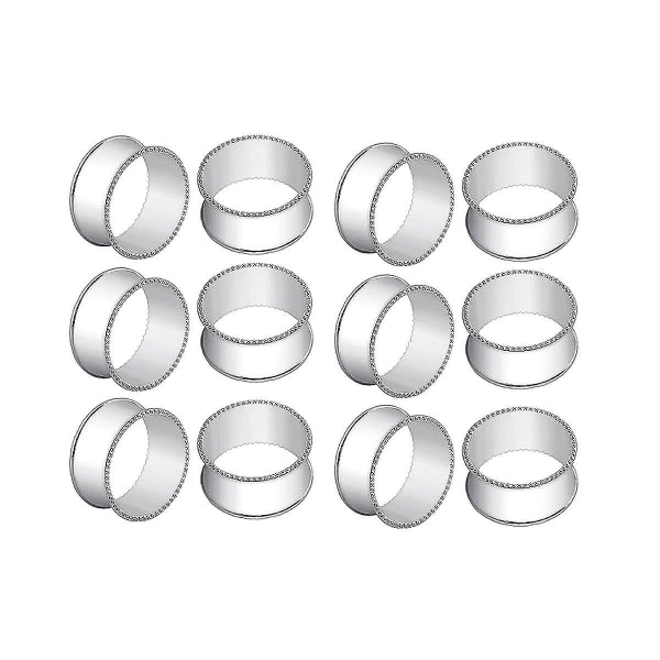 12 hopeaa rummun muotoisia helmiäispuoleisia lautasliinarenkaita. Herkät lautasliinasoljet