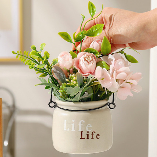 Konstgjorda blomsterarrangemang i kruka bordsdekoration