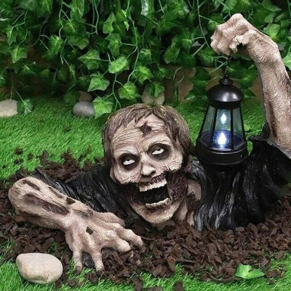 Tähti Halloween-koristeet - Zombi ryömii LED-lyhdyllä, Zombi pitelee lamppupatsasta.