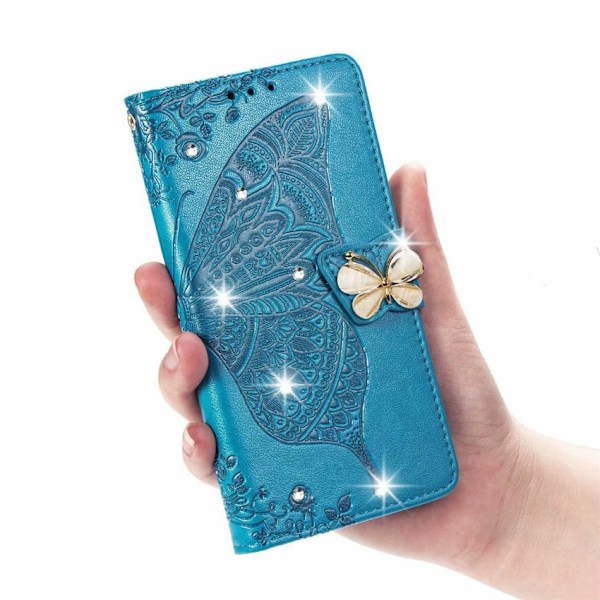 Fodral för iPhone 14 blå borrad 3D blomma fjäril läder diamantpräglad skiva