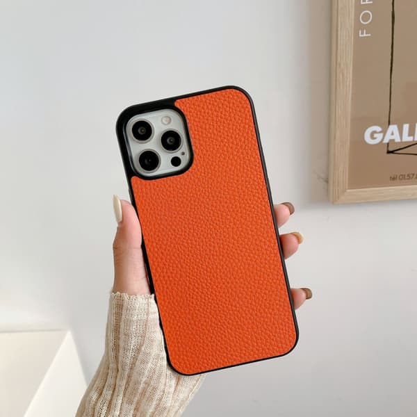 Fodral för iPhone16E Orange litchiläder Retro mönster