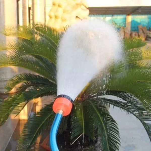 Blomsterhave sprinkler, drivhusplanter bruser græsplæne