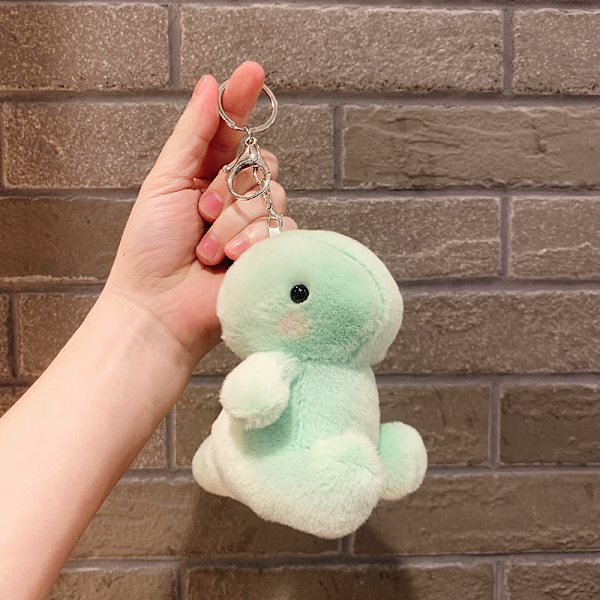 Söt liten docka, parväska hänge, plyschleksak docka nyckelring, docka hänge Plush Sitting Dinosaur - Light Green