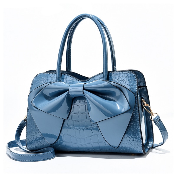 Ny handväska i ljust läder med stor rosett och crossbody-väska med en axel