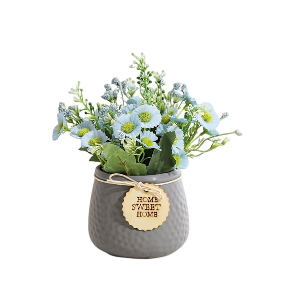 Liten kunstig daisy-blomst i keramisk potte for hjemmet