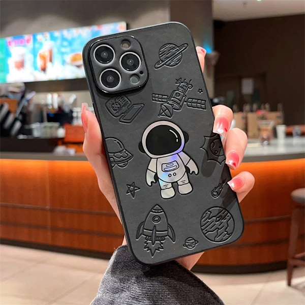 Kotelo iPhone 14plus -puhelimelle, musta avaruusmies, laserastronautti, nahkainen tekstuuri, sarjakuva-astronautti