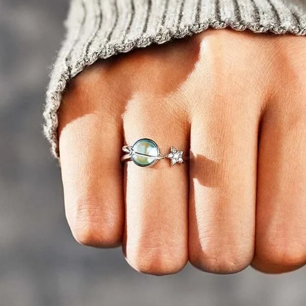 Min datters stressreducerende fidget spinner-ring, en planetformet ring til at lindre angst, en snurrende ring jeg gav til min datter.