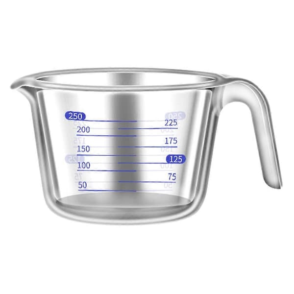 Klar mätkopp i glas för bakning och matlagning med skala