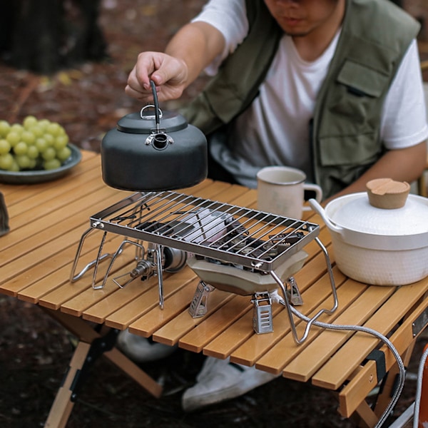 Justerbart hopfällbart lägereldsställ i rostfritt stål för utomhusgrillning
