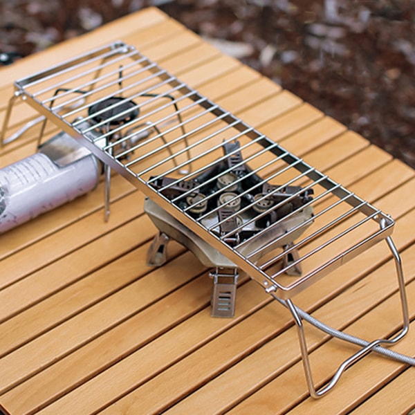 Justerbart hopfällbart lägereldsställ i rostfritt stål för utomhusgrillning