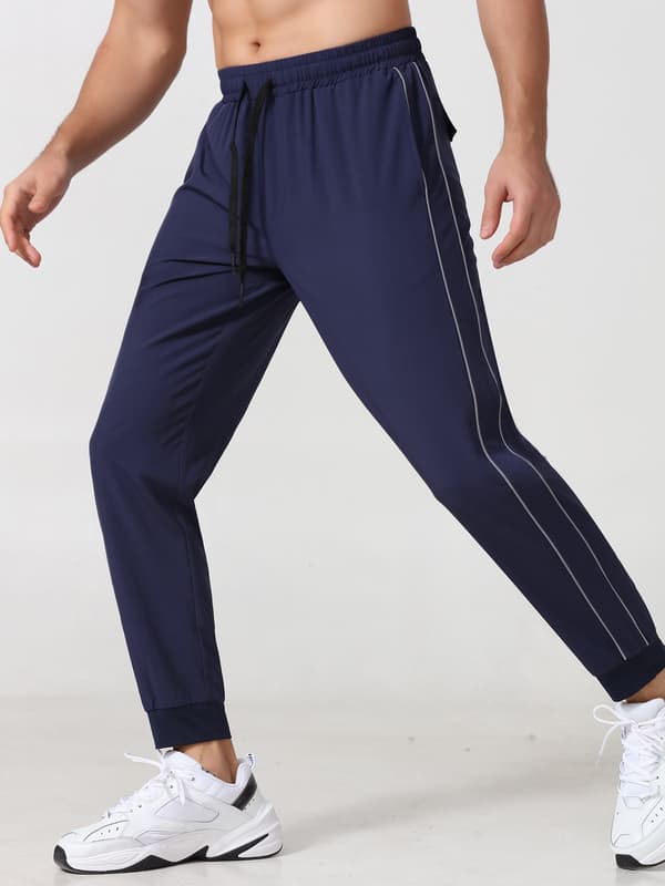 Joggebukse for menn med refleksstriper, lommer og elastisk linning for løping og trening