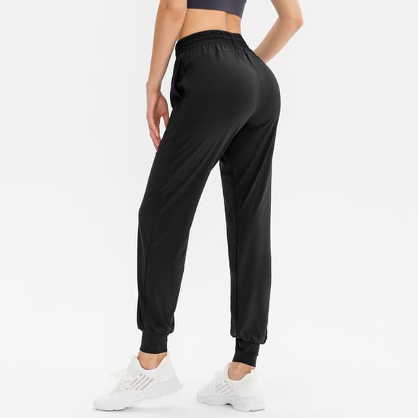 Joggingbukser til kvinder med lommer og elastisk linning til løb, træning, cykling og yoga.