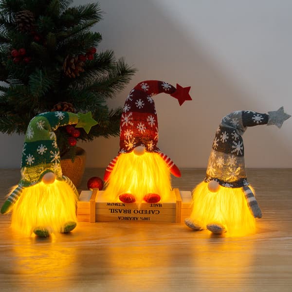 1 harmaa kasvoton nukke valoisalla Rudolph-kääpiöpehmonukella