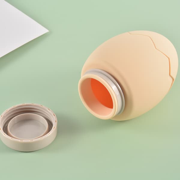 Vannfylt eggformet håndvarmepose, kvinnelig magevarmer, varm kompress