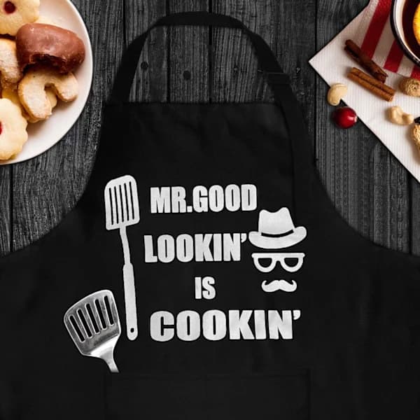 Grillforklæde til mænd med 2 lommer Sjov \"Mr. Good Lookin' Is Cookin'\" Gave til grillentusiaster Sort