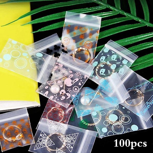100 st/lot 4x5cm Låspåsar Genomskinlig plastpåsar med dragkedja med print för matförvaring Smyckeförpackningspåsar Söt Mini Zip COLOR B