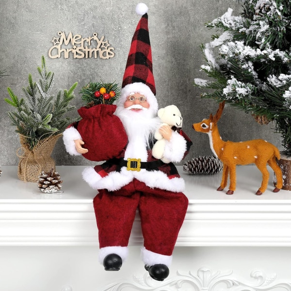 Handgjord sittande jultomtefigur med presentpåse och liten
