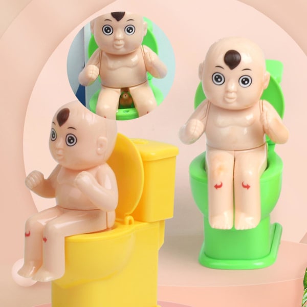 Pissaavan pojan ruiskutuslelu Ruiskutus vessassa istuva pikkupoika Innovatiiviset pakko-wc-nukkelelut