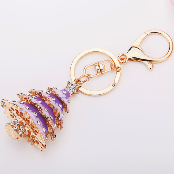 1 lila julgransnyckelring med roséguldfärgad berlockhänge med delad ring