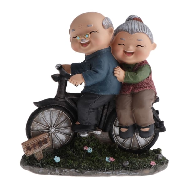 lyckliga äldre par statyett harts ålderdomsliv heminredning cykel