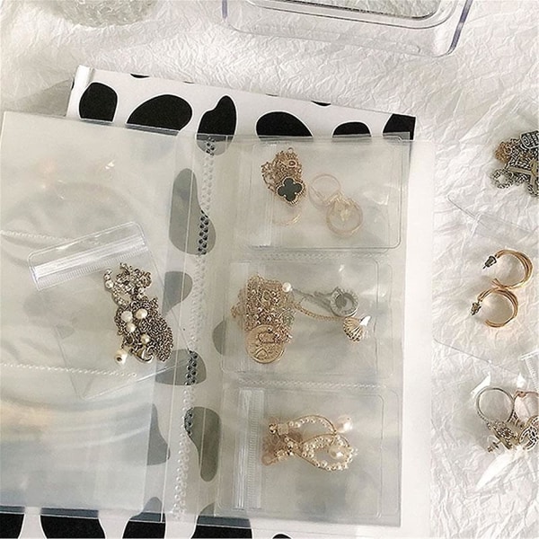 Owsen Transparent Smyckesförvaringsbok, Örhänge Organizer Bok, Anti-Oxidation Smyckesförvaring (84 Fack + 50st Smyckesförvaringspåsar)