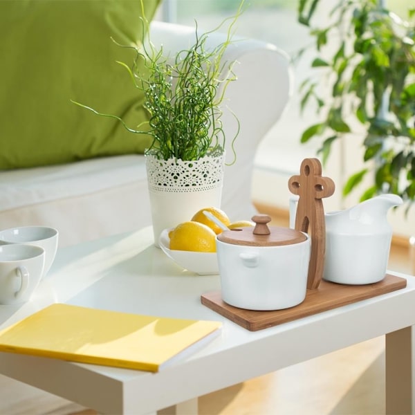 Elegant sukkerskål af porcelæn og flødekande på bambusbakke